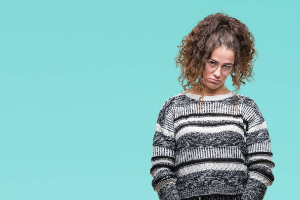 Beautiful brunette curly hair young girl wearing glasses over isolated background depressed and worry for distress, crying angry and afraid. Sad expression. - Photo, Image
