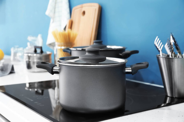 Saucepan on stove in kitchen - Fotó, kép