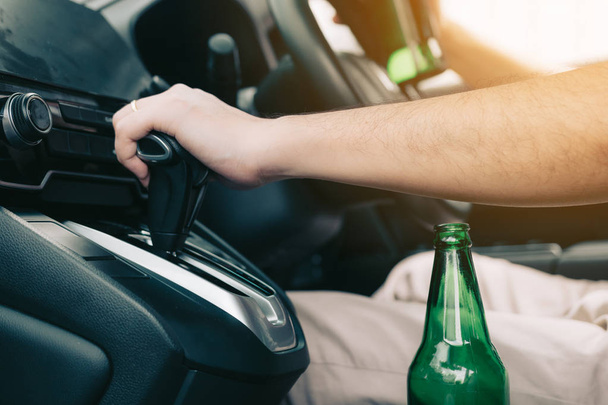 Men are in the car's gear and ready to leave while having a beer - 写真・画像