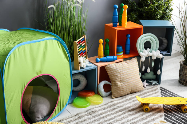 Stylish interior of kid room with tent - Foto, imagen