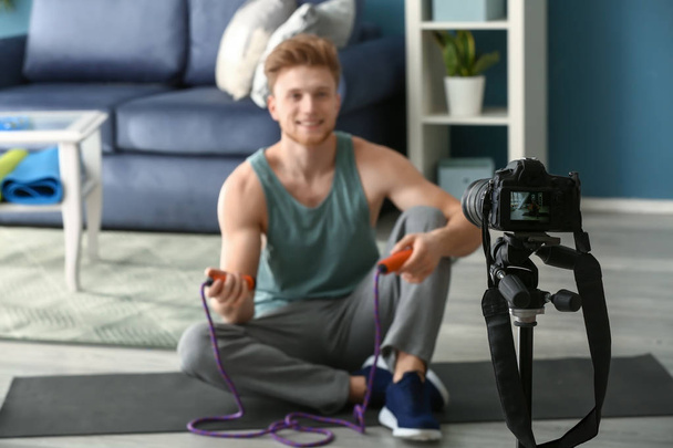 Young male sport blogger recording video at home - Valokuva, kuva