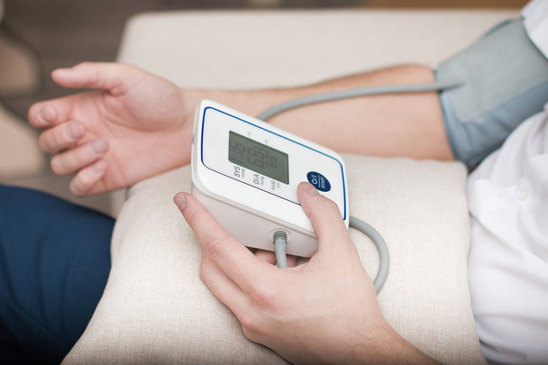 Measurement of blood pressure by an electronic tonometer. - Photo, Image