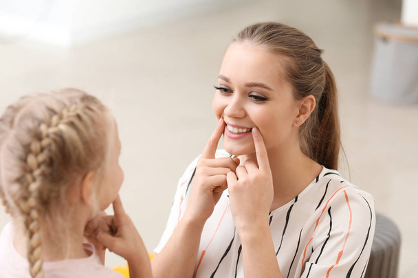 Speech therapist working with little girl in office - Photo, Image