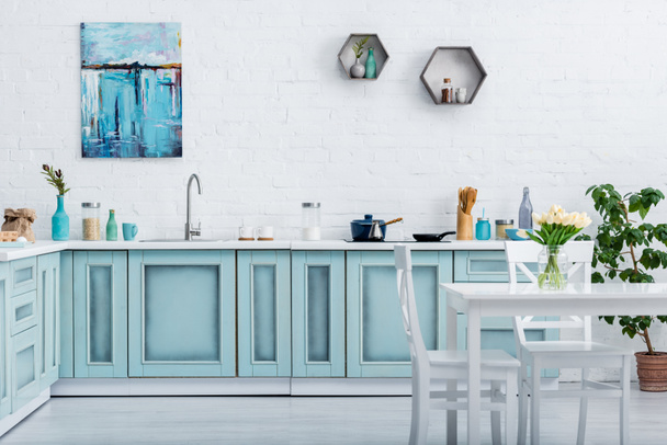 interior of turquoise and white elegant kitchen with kitchenware and decor  - Foto, imagen
