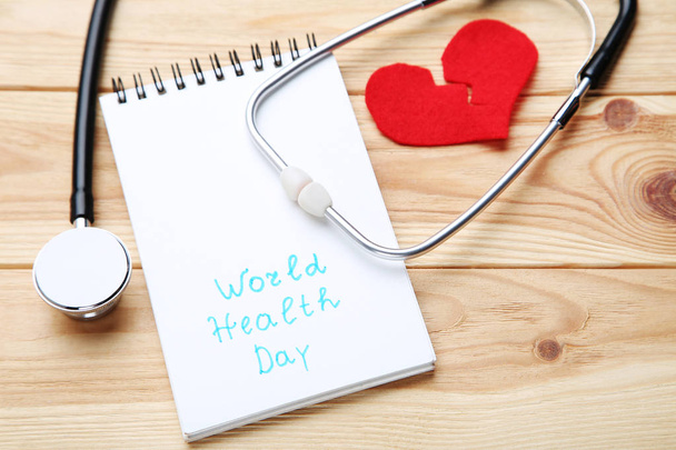 Text World Health Day with stethoscope and red heart on brown wo - Foto, immagini