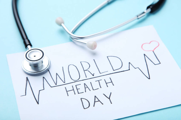 Text World Health Day with stethoscope on blue background - Φωτογραφία, εικόνα