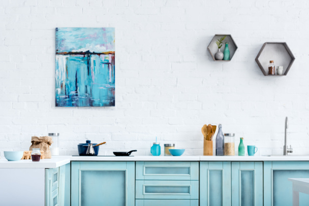 interior of modern kitchen with painting on white brick wall - Photo, Image