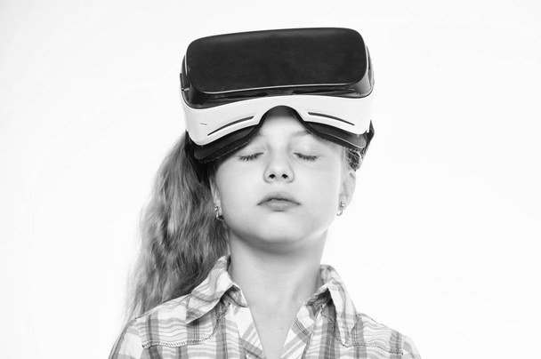 Small kid use modern technology virtual reality. Virtual education for school pupil. Get virtual experience. Girl cute child with head mounted display on white background. Virtual reality concept - Фото, изображение