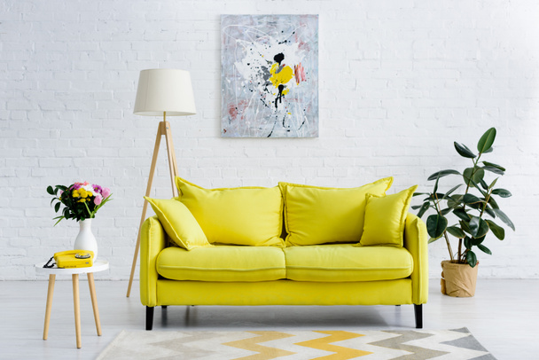 interior of cozy living room with bright yellow elements, decor and retro telephone - Photo, Image