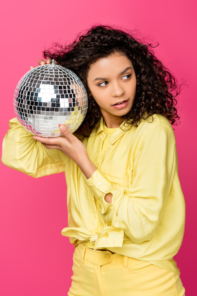 atraente afro-americano mulher segurando brilhante bola de discoteca isolado no carmesim
 - Foto, Imagem