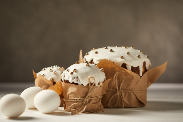 delicious easter cakes and chicken eggs on white table with copy space - Foto, Bild