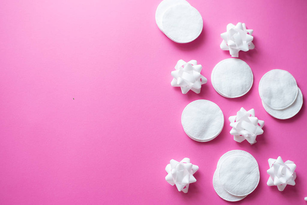 cotton pads on pink background, top view. Beauty, skin, body care concept.selective focus. place for text. frame - Photo, Image