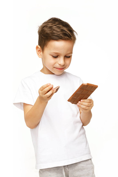 little beautiful boy holding chocolates studio shot  - Zdjęcie, obraz