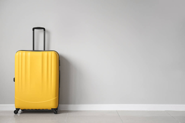 Packed suitcase near light wall - Photo, Image