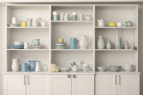 Cupboard with clean dishes in kitchen - Photo, Image