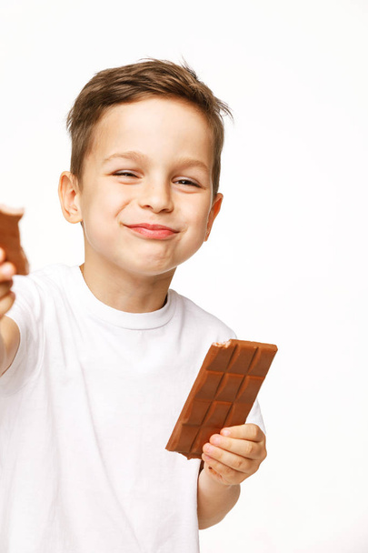 little beautiful boy holding chocolates studio shot  - Photo, image