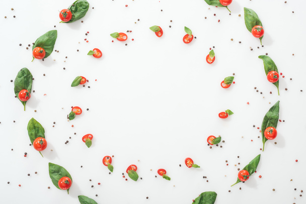flat lay with spices and sliced chili peppers with basil and ripe cherry tomatoes - Foto, imagen