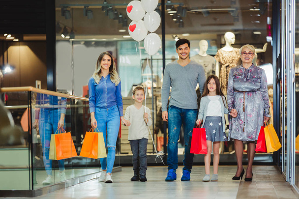 Family shopping for clothes and looking happy - Foto, Imagen