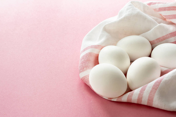 white eggs on a towel breakfast for family in the country, on a pink background - Fotoğraf, Görsel