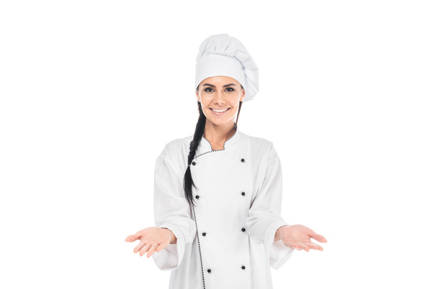 Smiling chef in hat showing shrug gesture isolated on white - Valokuva, kuva