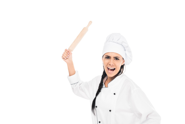 Angry chef in hat holding rolling pin and screaming isolated on white - Fotografie, Obrázek