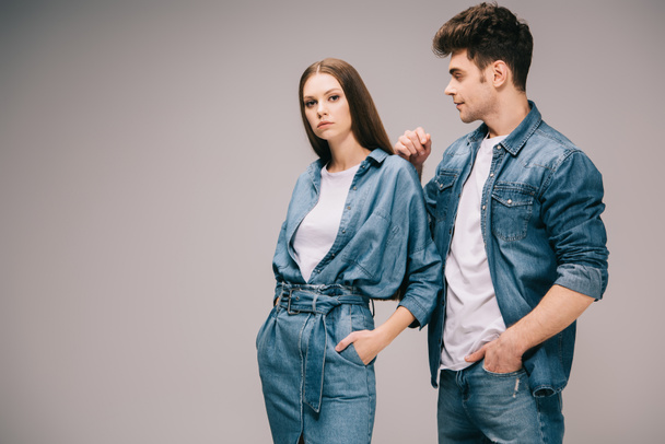 girlfriend in denim dress and boyfriend in jeans and shirt on grey background  - Φωτογραφία, εικόνα