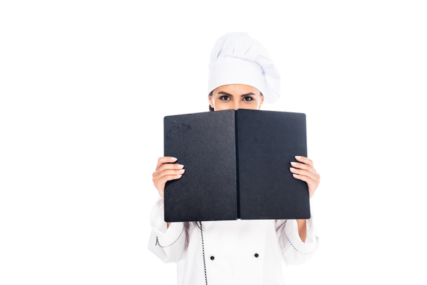 Chef in uniform holding black book isolated on white - Foto, afbeelding