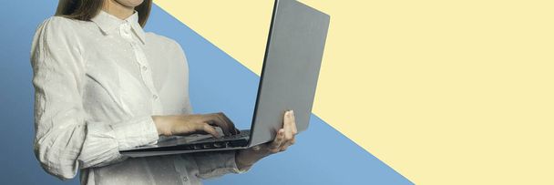 Girl with laptop in hands on a colored background - Foto, immagini