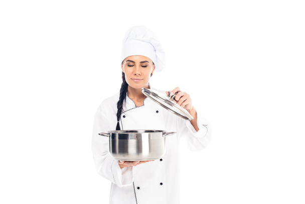 Chef in uniform holding steel pot with closed eyes isolated on white - Photo, Image