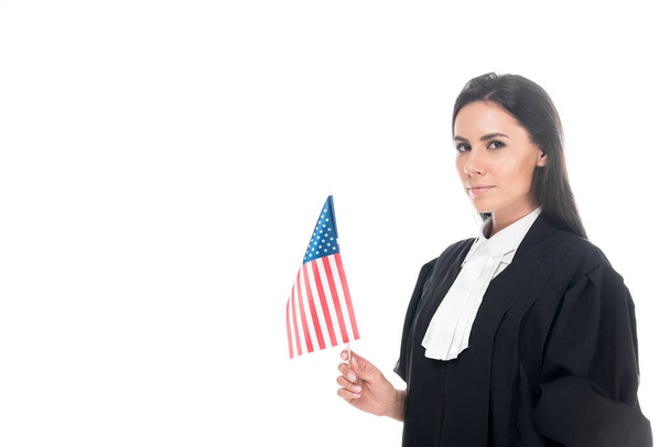 Judge in judicial robe holding american flag isolated on white - Fotó, kép