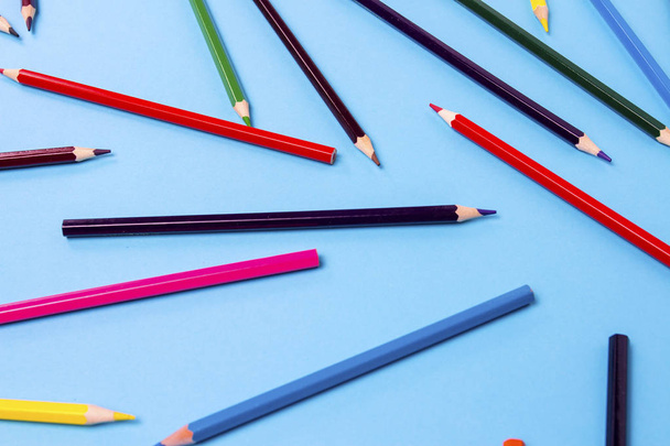 Color pencils scattered throughout the frame on a black background - Fotoğraf, Görsel