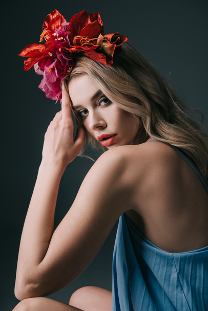 beautiful and blonde woman in colorful wreath looking at camera isolated on black - Photo, Image