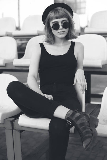 Young woman sitting in a stadium. Black and white - Foto, immagini