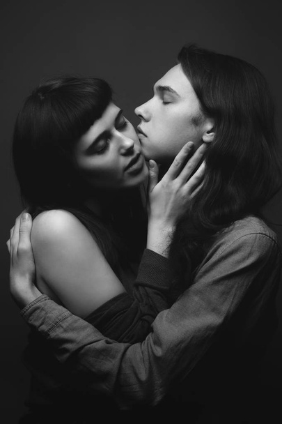 Young man and girl are kissing. Black and white - Zdjęcie, obraz