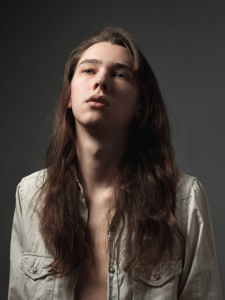Portrait of the young man with long hair. - Foto, imagen
