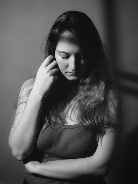 Portrait of a sad woman. Black and white. Low key - Foto, imagen
