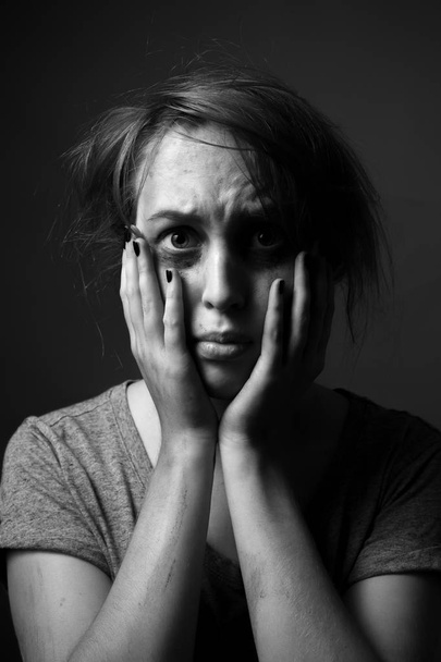 Scared  woman with smeared make up. Low key. Black and white - Photo, Image