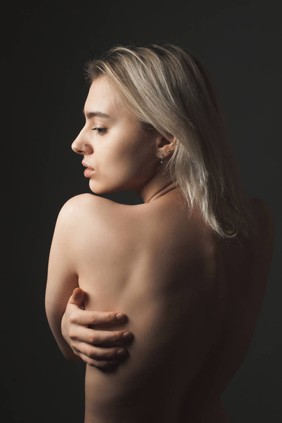 Beautiful young woman topless on black background - Fotografie, Obrázek