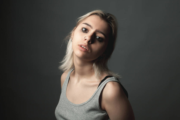 Portrait of depressed  young woman on the black background - Fotó, kép