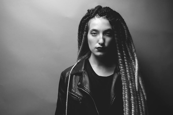 Black and white portrait of attractive young female with braids. High contrast - Photo, Image