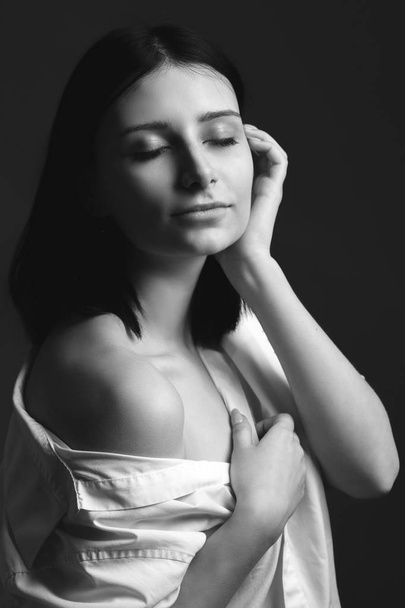 Young woman in white shirt. Black and white - Фото, изображение
