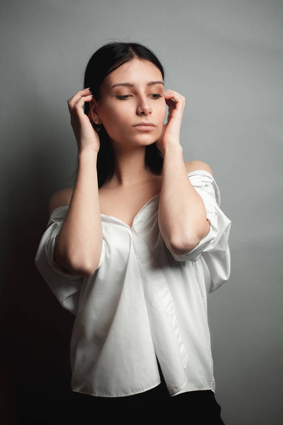 Attractive woman in white shirt with bare shoulders - Fotografie, Obrázek