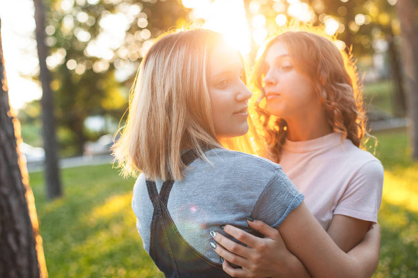 Two girls having fun in park at sunset - Fotografie, Obrázek