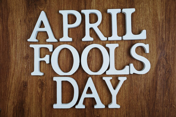 April Fool's Day alphabet letter with space copy on wooden background - Foto, Imagem