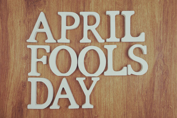April Fool's Day alphabet letter with space copy on wooden background - Foto, Imagem