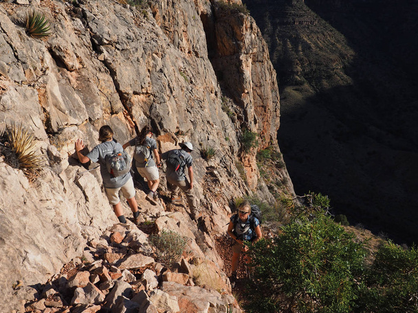 Backpackers on a steep, narrow trail in the Grand Canyon. - Photo, Image