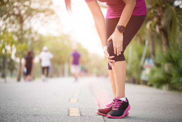 Runner sport knee injury. Woman in knee pain while running work  - Photo, Image