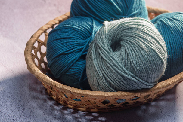 balls of colored yarn in a wicker basket close-up - Zdjęcie, obraz