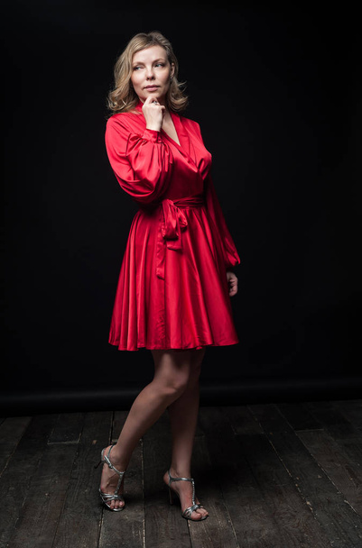 Sexy blonde in red dress in Studio - Φωτογραφία, εικόνα