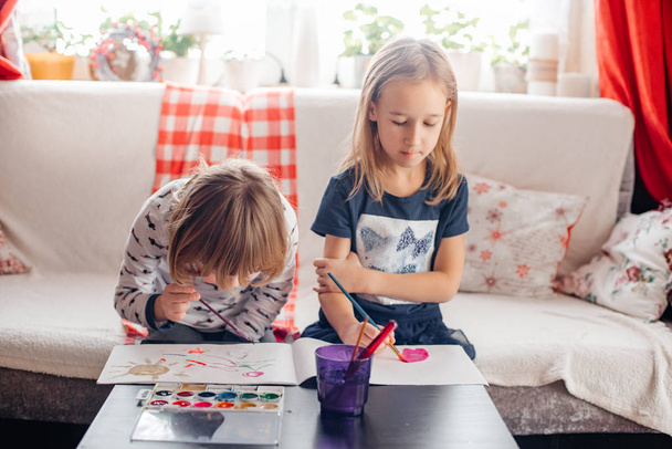 two little girls painting at Living Room - 写真・画像